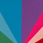 Vibrant abstract composition of colorful paper arranged in fan-like pattern.